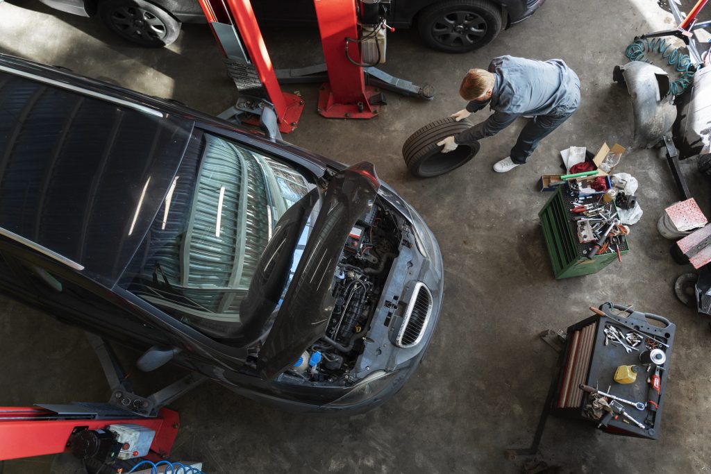top view man repairing car
