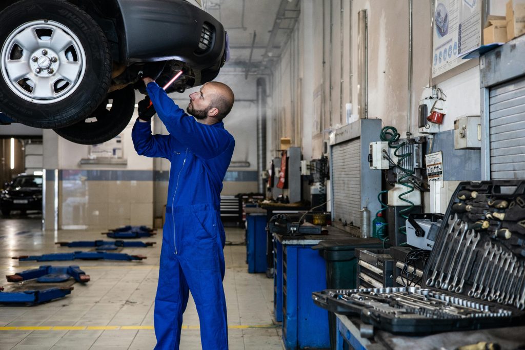 Technician fitting new brake parts on a vehicle inside PPC Garage workshop in Thanet.